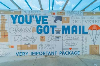a sign that says youve got mail in front of a building